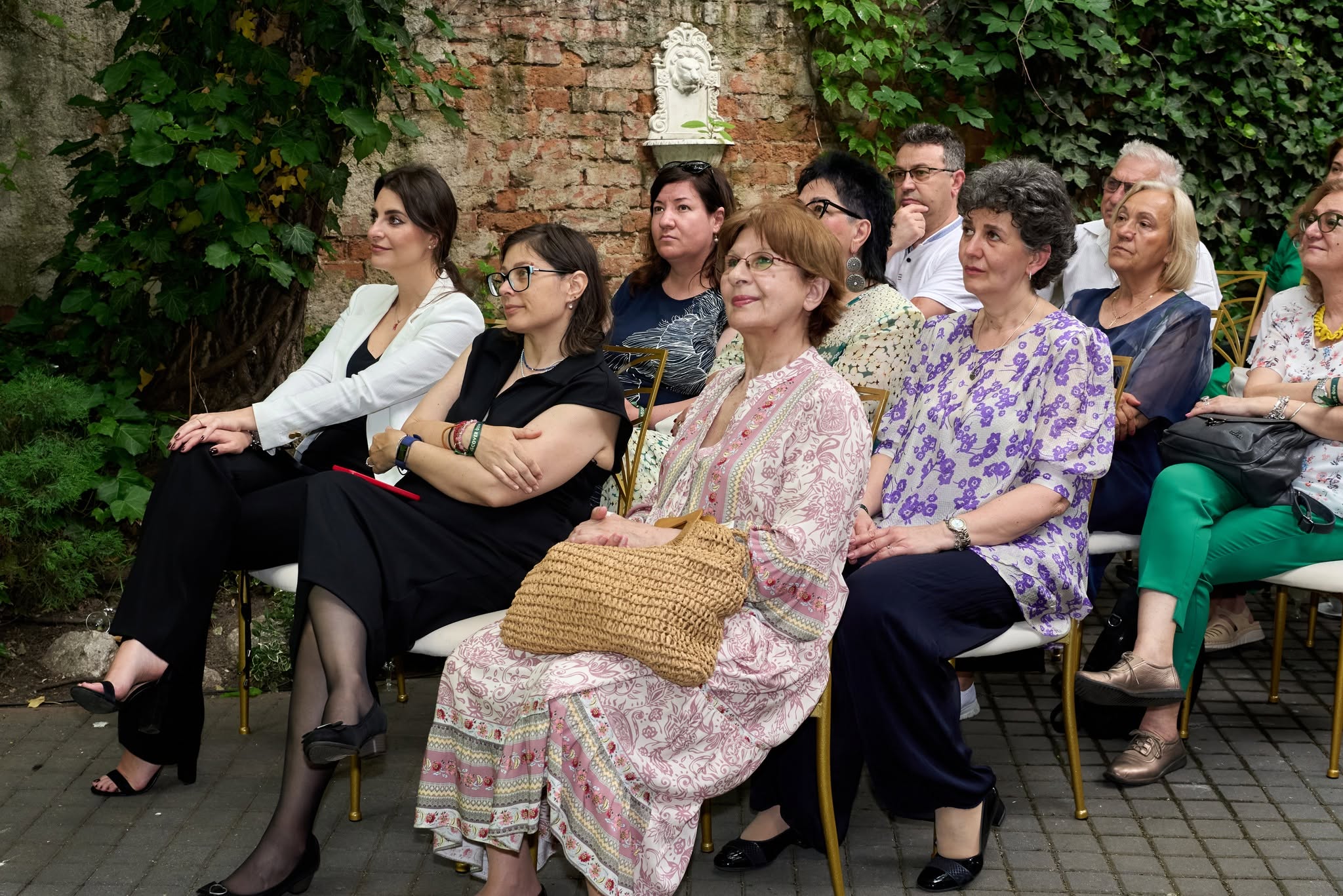 Participante ascultând prezentarea în curtea Palatului Noblesse — EVERDREAM 2026 România, scaune aurii