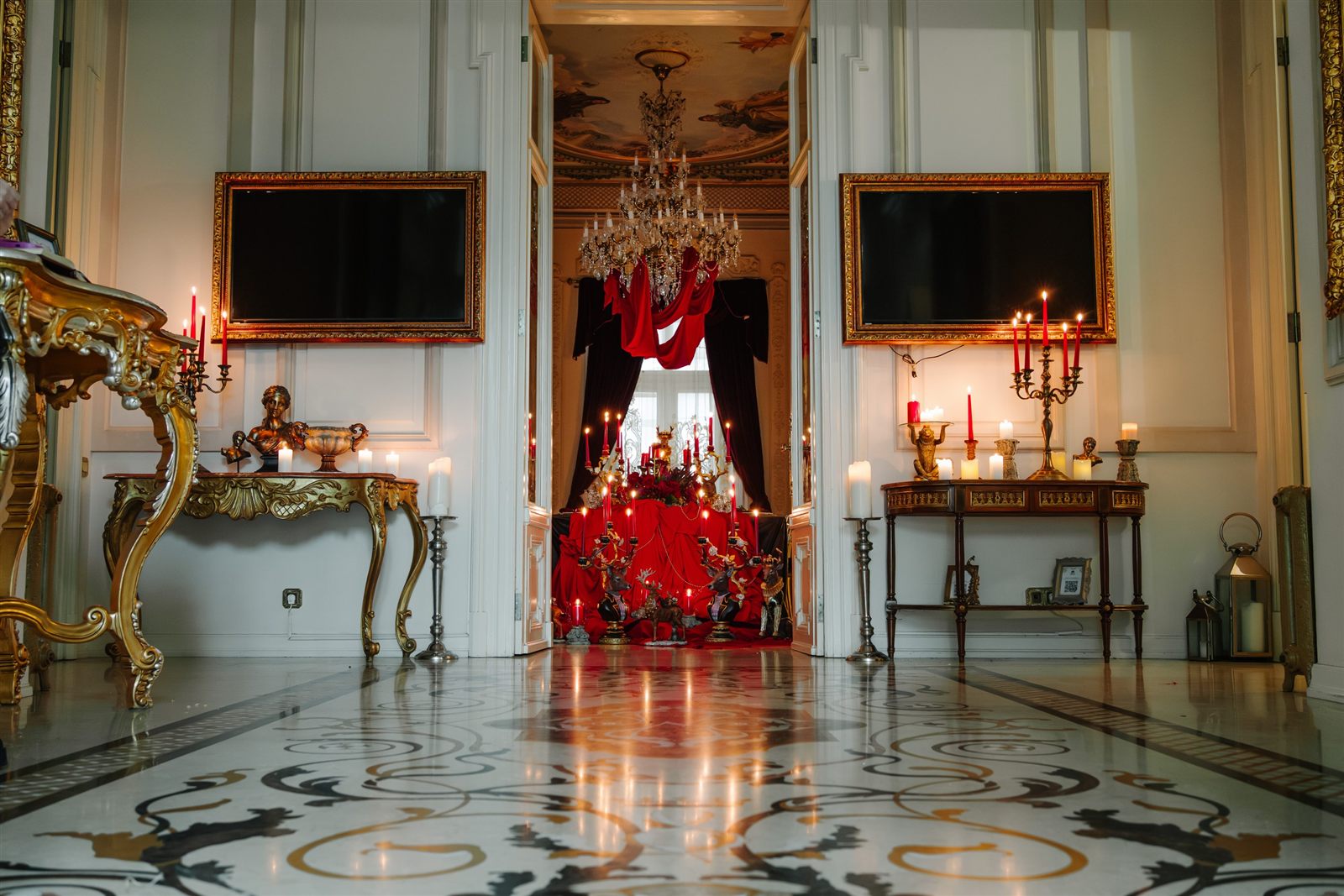 Salon de gală cu candelabre, console aurii și masă festivă în roșu, în perspectivă, la Palatul Noblesse