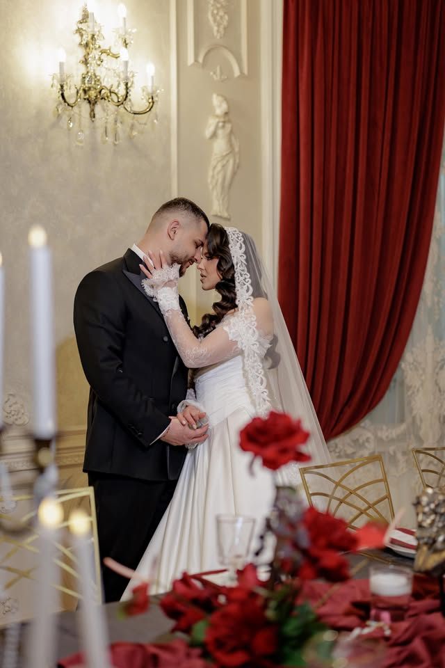 Miri sărutându-se în decorul roșu cu sfeșnice — Salonul Baroque, Palatul Noblesse