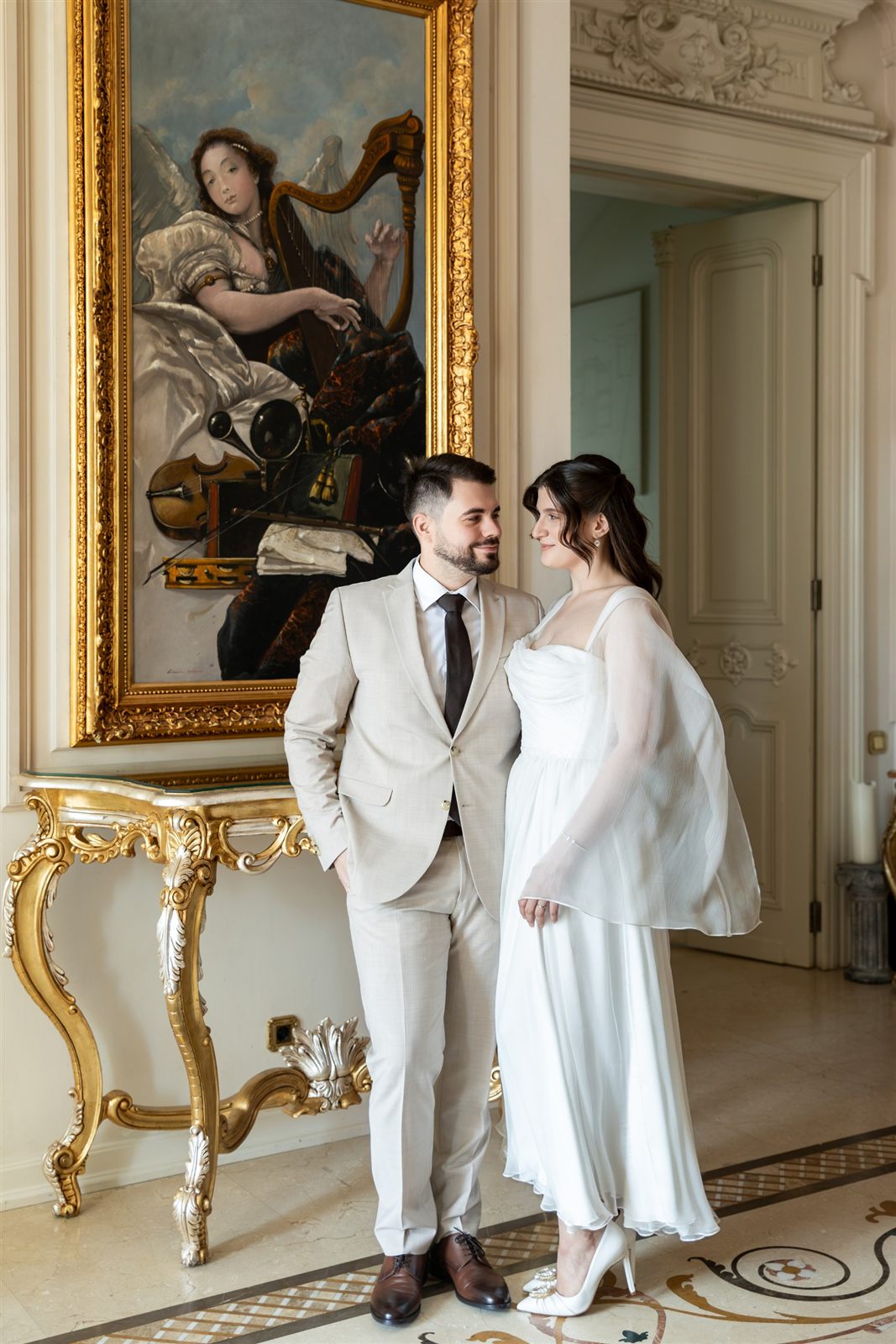 Cuplu de miri lângă un tablou de epocă — ședință foto de cununie la Palatul Noblesse