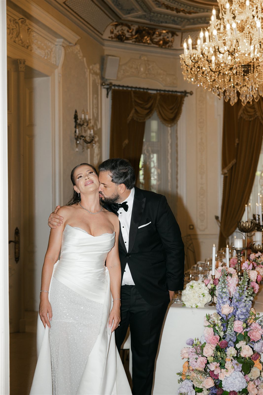 Cuplu de miri sarutandu-se in decorul de nunta la Palatul Noblesse